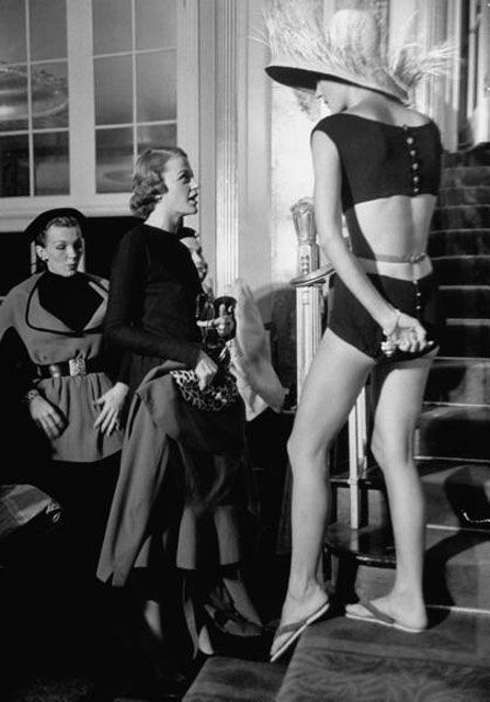 "Designer Bonnie Cashin (R), talking with models wearing clothes she designed in the midst of a fashion show."
